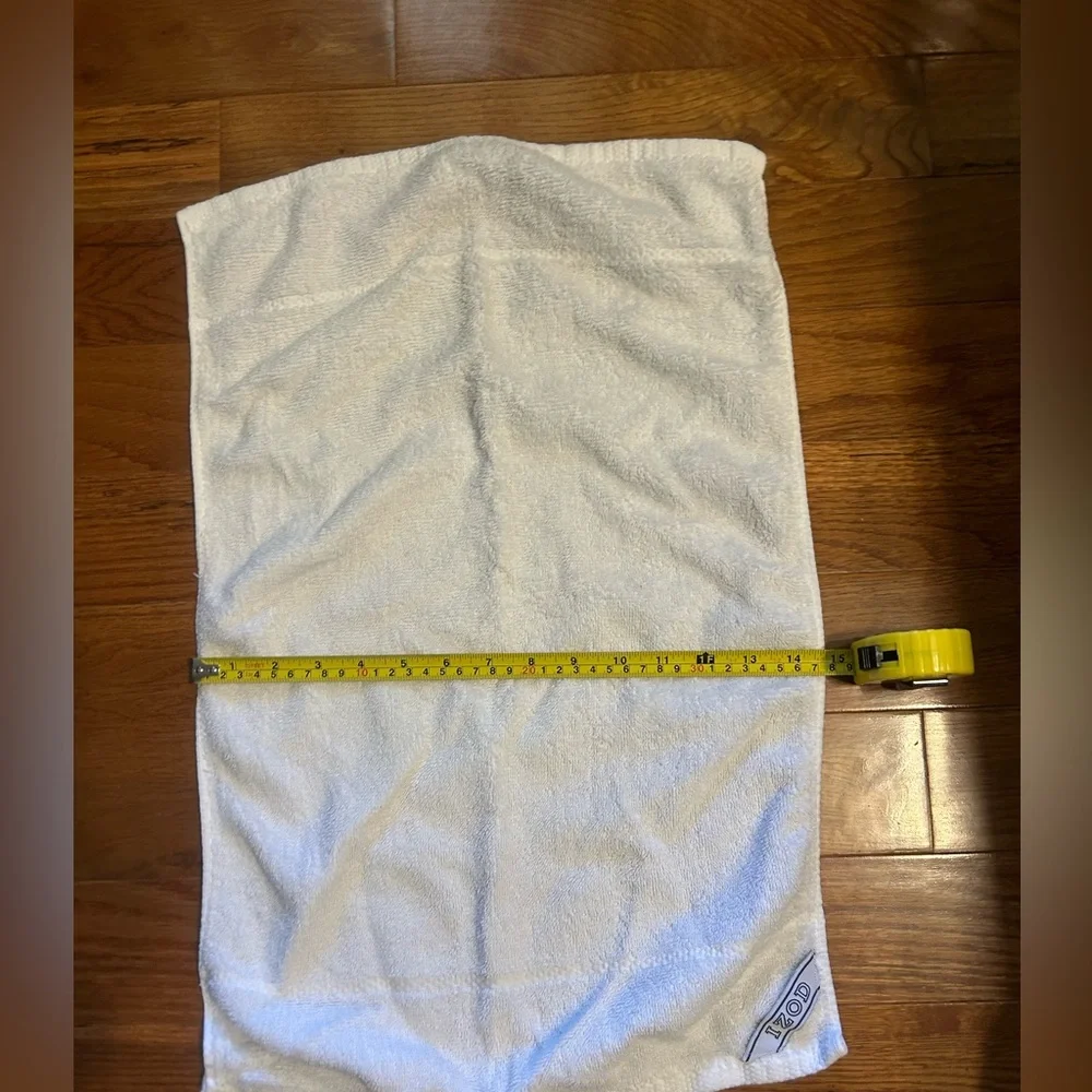 2 sports towels. 1 is reversible and has a tennis player. 1 is izod brand.